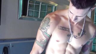 Inked guy Tattoo Boy strokes his cock intensely after a short photoshoot