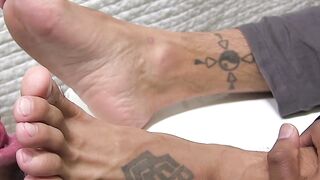 Black and white hunks enjoy a feet sucking session together