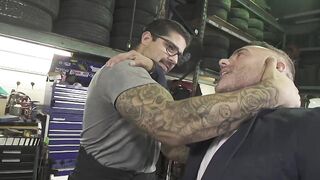 Dominant car mechanic subdues handsome hunk for feet worship