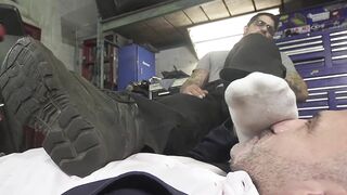 Dominant car mechanic subdues handsome hunk for feet worship