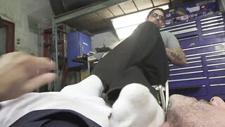 Dominant car mechanic subdues handsome hunk for feet worship