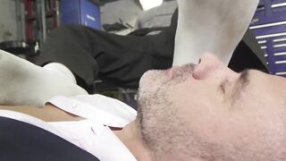 Dominant car mechanic subdues handsome hunk for feet worship