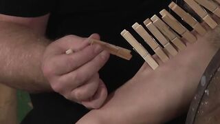Master punishing his young sub with dozens of clothespins