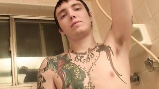 Straight youngster with tatts stroking his swollen dick