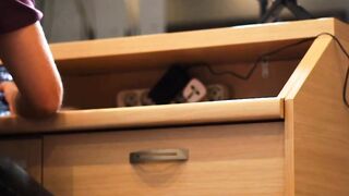 Fucking a red head behind her working desk