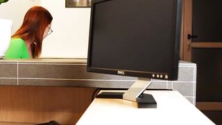 Fucking a red head behind her working desk