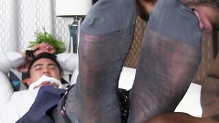 Jock Axel Kane is bound on the couch and got his foot worshipped by black hunk August