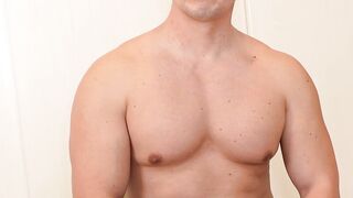Buff and muscular Nozomu lubes his erect cock while doing an interview