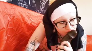 This nun blows her big black dick toy
