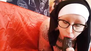 This nun blows her big black dick toy