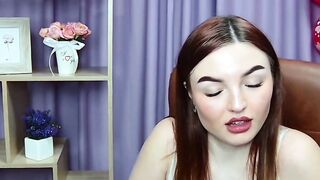Busty redhead strips bra closeup