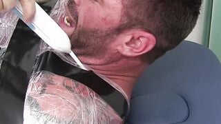 Restrained hunk endures tickling torment from his dom