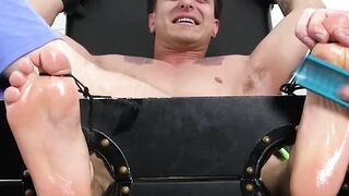 Restrained hunk enjoys his toes getting worshiped by a man