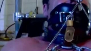 MuscleJockBound.com - Muscular man silenced with a ball gag while being heavily chain