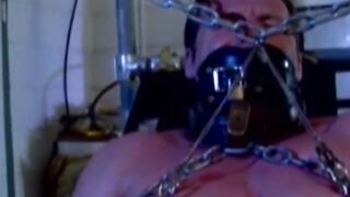 MuscleJockBound.com - Muscular man silenced with a ball gag while being heavily chain