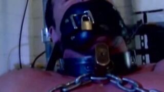 MuscleJockBound.com - Muscular man silenced with a ball gag while being heavily chain