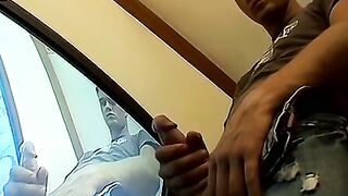 Thug pleases himself with his hands next to recording TV