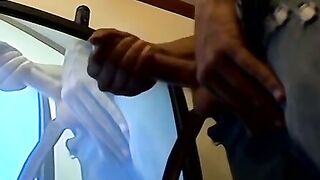 Thug pleases himself with his hands next to recording TV