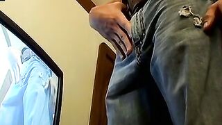 Thug pleases himself with his hands next to recording TV