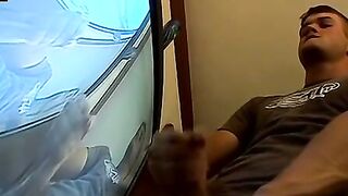 Thug pleases himself with his hands next to recording TV