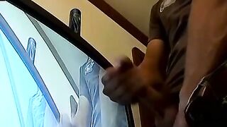Thug pleases himself with his hands next to recording TV