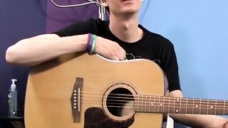 Young man plays guitar before dick stroking and cumming