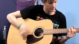 Young man plays guitar before dick stroking and cumming
