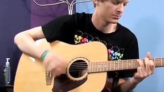 Young man plays guitar before dick stroking and cumming