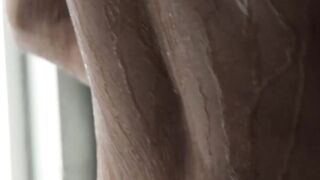 Young man strips to wash his tight body before masturbating