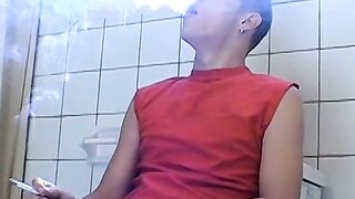 Attractive Yuri fires up his cig and sits on the toilet for his hot smokin and stroki