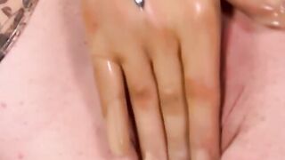 Busty masked babe in full latex suit finger fucks herself