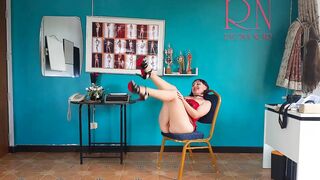 An elegant lady employee inside red panties undresses into the office. one