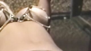 Busty blonde sub tied up for spanking in BDSM dungeon