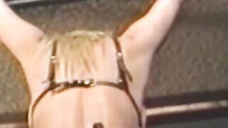 Busty blonde sub tied up for spanking in BDSM dungeon