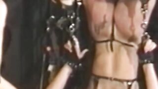 Busty blonde sub tied up for spanking in BDSM dungeon
