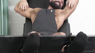 Macho dude with hairy chest and beard has his toes tickled