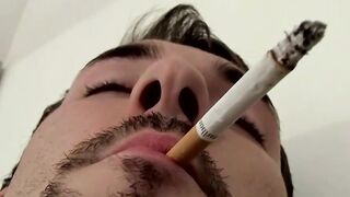 Attractive Paradox chainsmokin marlboro black while jerking his cock passionately