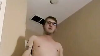 Tattooed amateur with glasses is stroking his massive dick