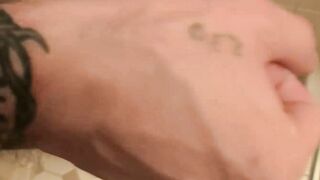 Inked jock Blinx rubbing his meaty cock in the shower and splashing his cum out