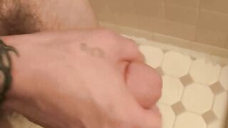 Inked jock Blinx rubbing his meaty cock in the shower and splashing his cum out