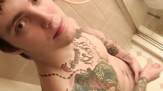 Inked jock Blinx rubbing his meaty cock in the shower and splashing his cum out
