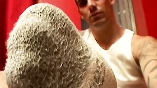 Evan Heinze plays with his feet in his socks before revealing his sexy bare soles