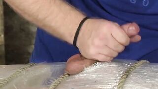 Bound young twink enjoys handjob from mature master