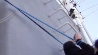 Young Asian cutie outdoors tied up and pees from the ladders