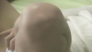 Tiny Japanese babe moistens her panties with pussy juices
