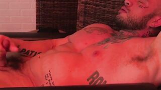 MaleFeetXXX.com - Muscular Davin strokes his cock while his feet are worshiped by his