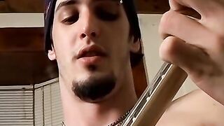 Horny straight thug Axel plays with the guitar and his cock
