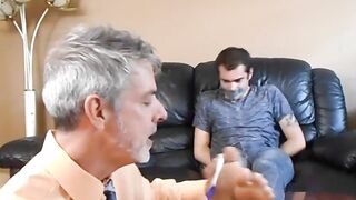 Professor Richard Lennox tickles the feet of his young student Kody Tracer.