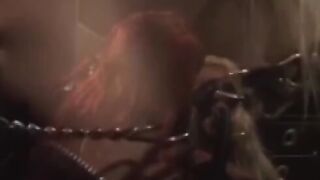 "Redheaded Dominatrix Uses Mega Dildo to Discipline Submissive Lesbians"