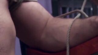 Dominatrix in leather thongs uses fists to dominate submissive slave